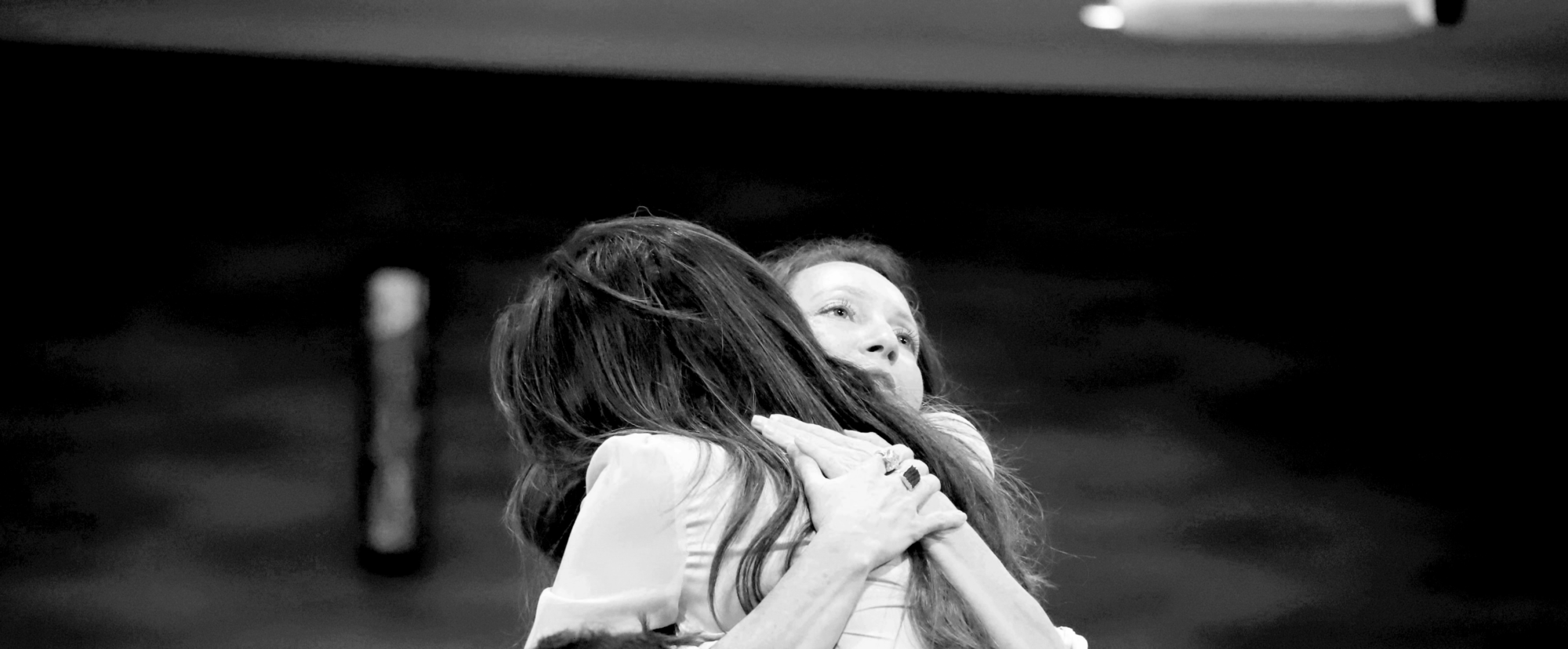 Two women hugging each other showing support