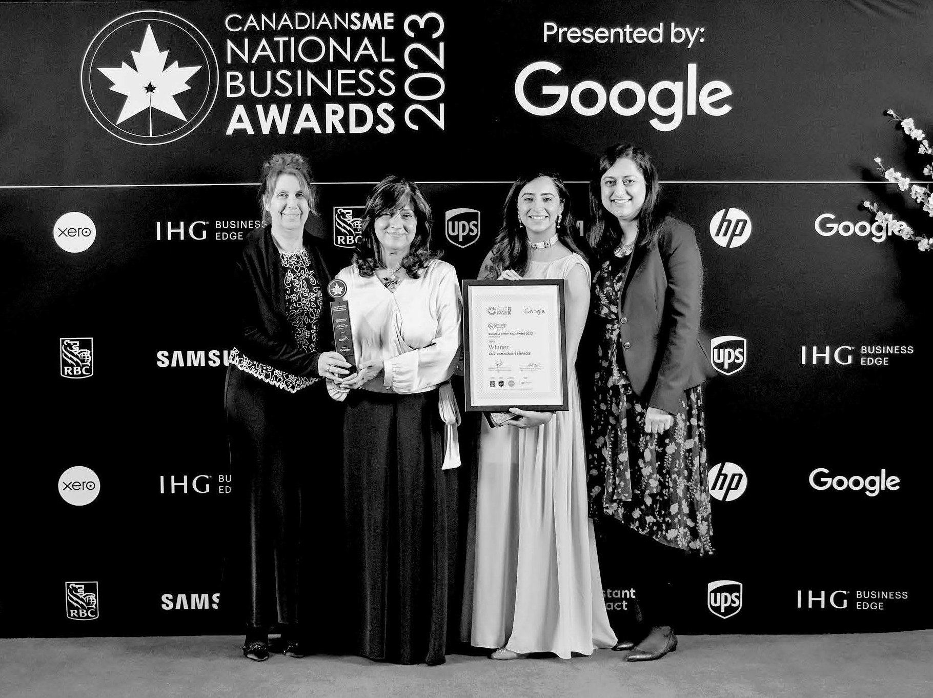 Senior Director Janet Hallett, CEO Samina Sami, Manager Communications and Events Anam Raheel and Senior Director People and Culture Robina Yasin are together holding a trophy and a laminated certificate, standing in front of an event backdrop that says, “CanadianSME National Business Awards 2023, presented by Google”